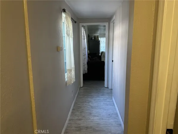 a view of a hallway with wooden floor