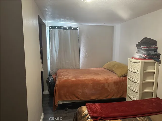 a bedroom with a bed and a chair