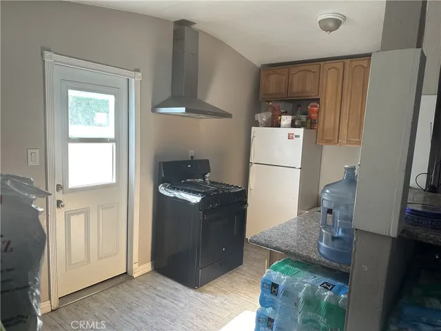 a kitchen with stainless steel appliances granite countertop a refrigerator and a stove