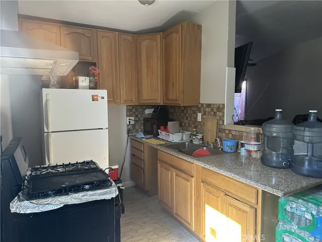 a kitchen with a refrigerator and a sink