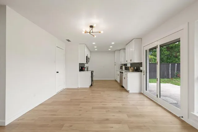 a view of a kitchen with a sink and a refrigerator