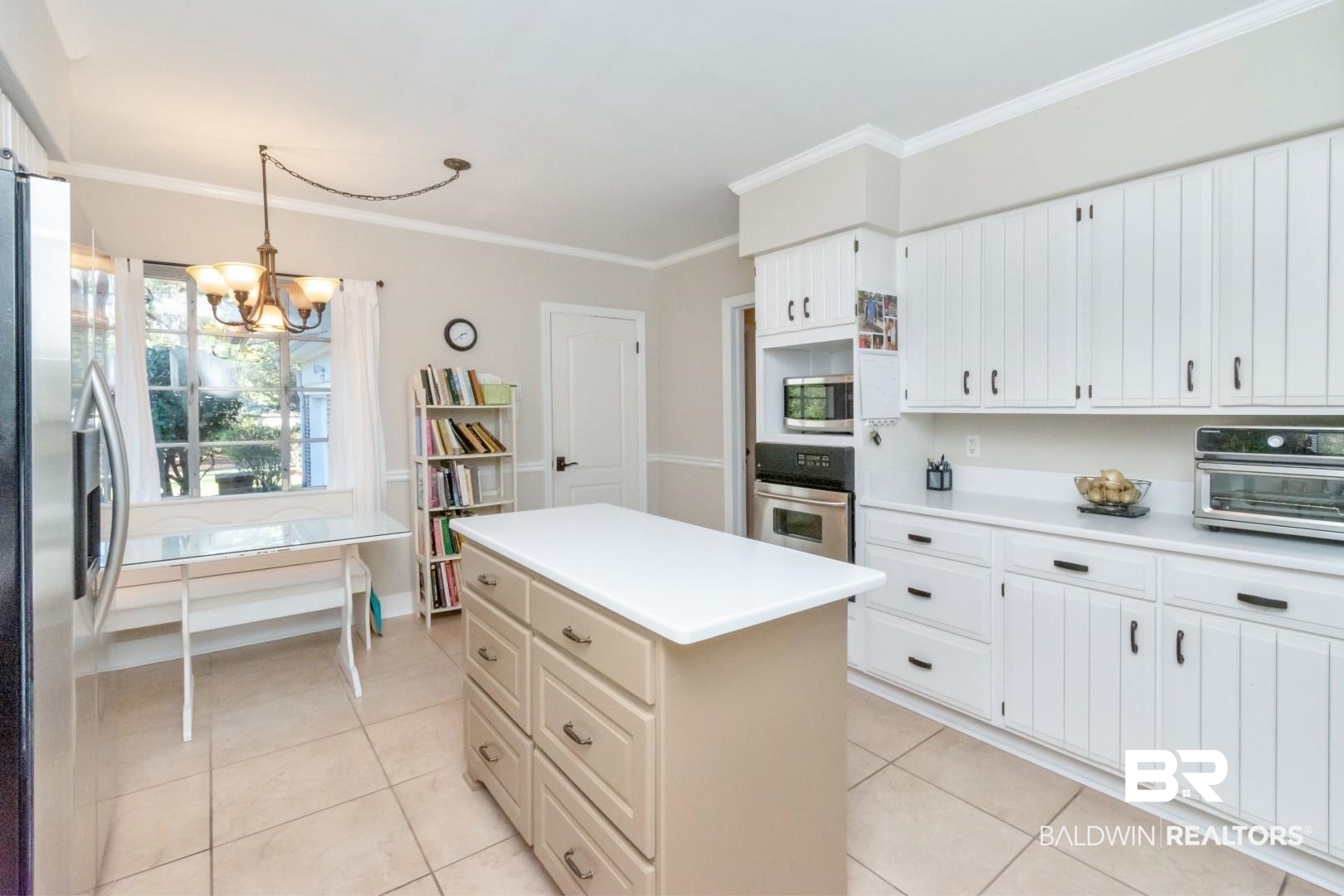 302 Springwood Drive East Mobile, AL 36608 - Photo 17 of 35 Kitchen featuring a center island, stainless steel appliances, a chandelier, decorative light fixtures, and ornamental molding