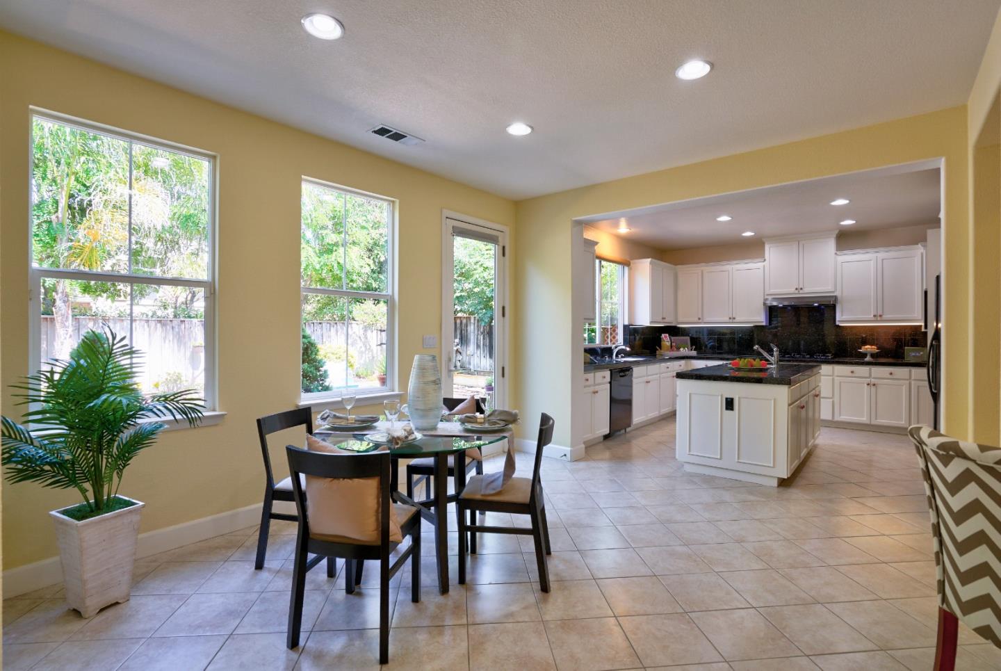2915 Silva Way San Ramon, CA 94582 - Photo 16 of 38 a kitchen with a dining table chairs and white appliances