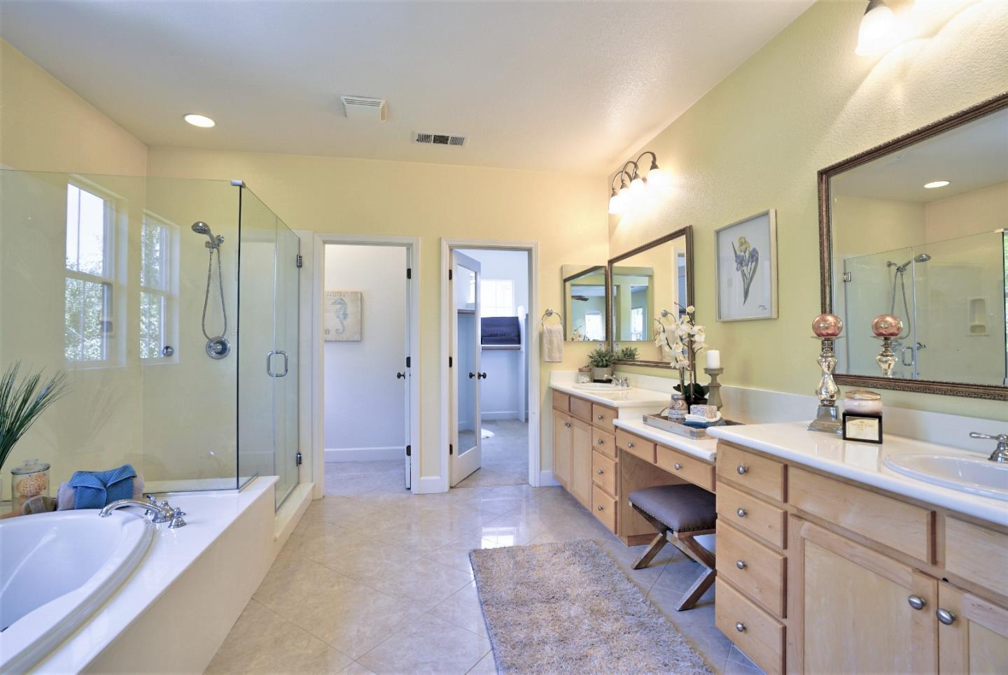 2915 Silva Way San Ramon, CA 94582 - Photo 27 of 38 a spacious bathroom with a sink a mirror a shower and a bathtub