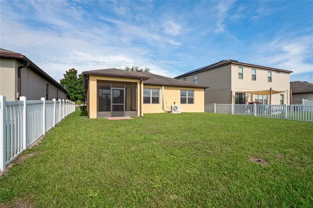 an aerial view of residential houses with outdoor space and swimming pool