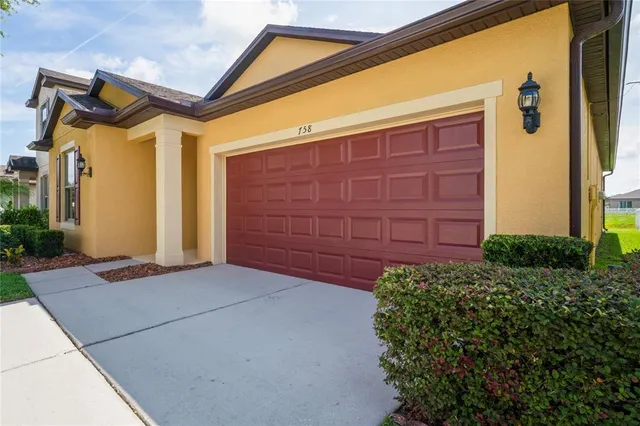 an aerial view of residential houses with outdoor space and street view