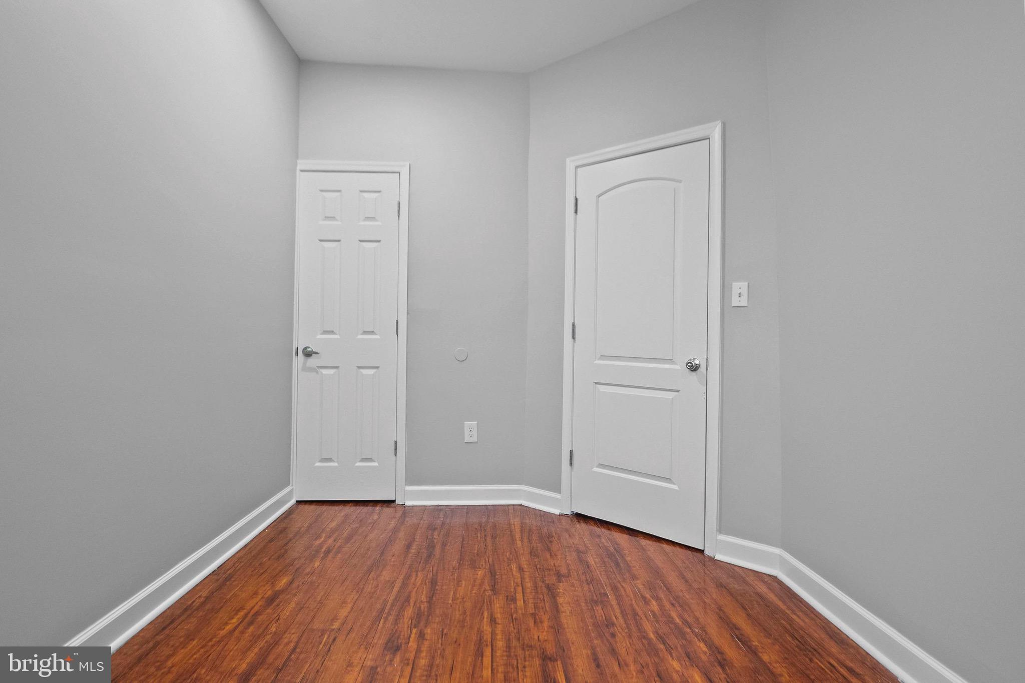 2706 Greenmount Avenue Baltimore, MD 21218 - Photo 12 of 20 an empty room with wooden floor and closet