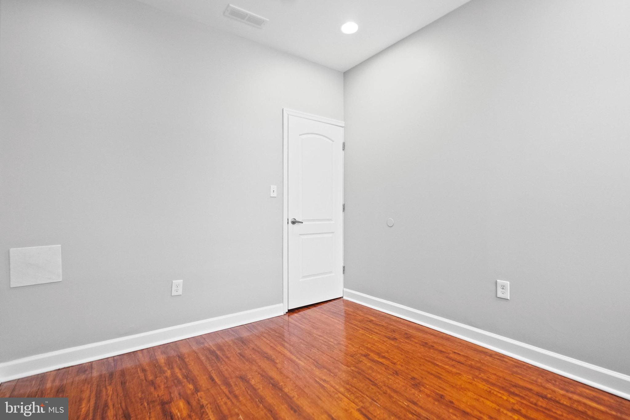 2706 Greenmount Avenue Baltimore, MD 21218 - Photo 14 of 20 a view of an empty room with wooden floor