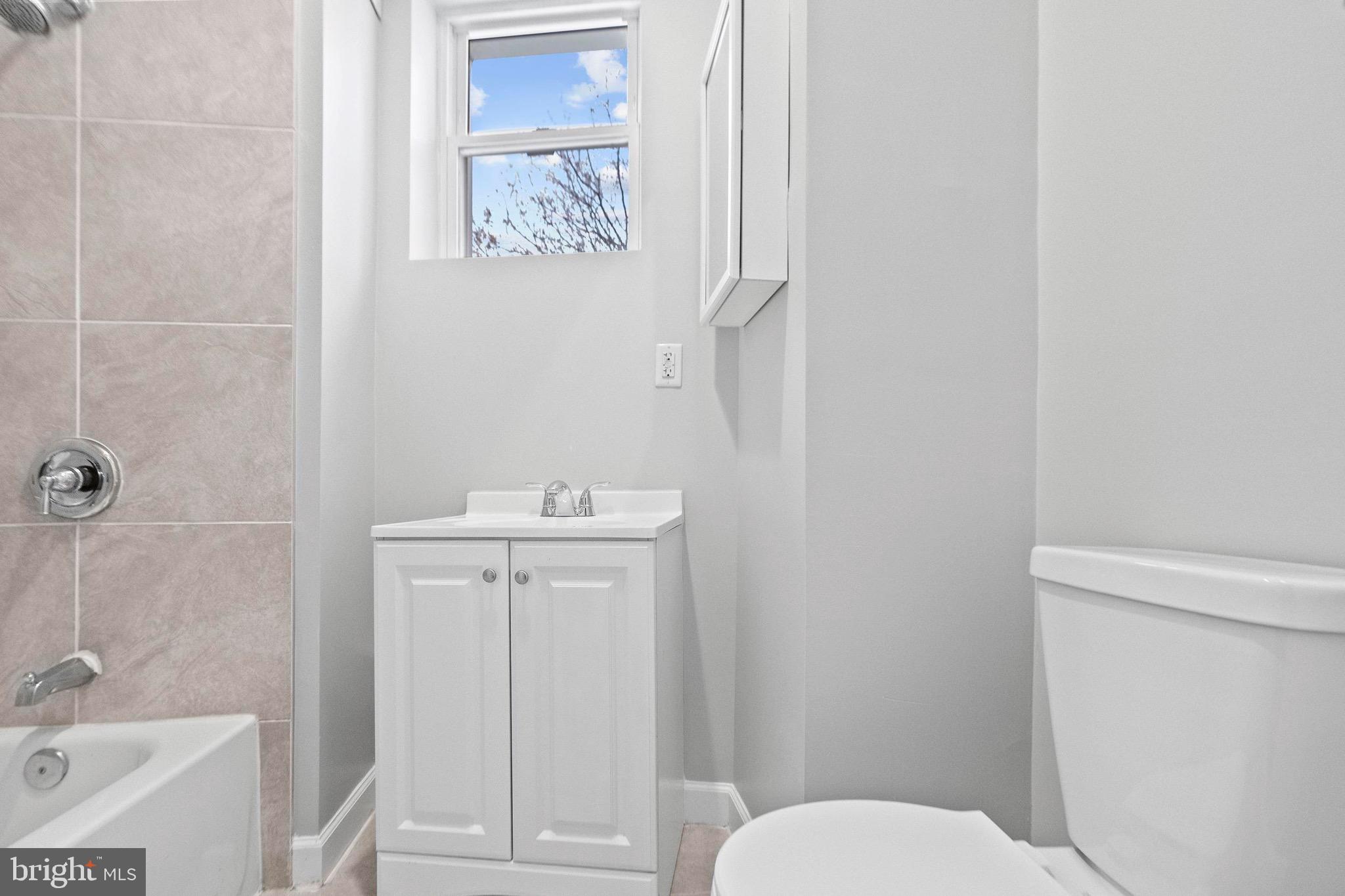 2706 Greenmount Avenue Baltimore, MD 21218 - Photo 15 of 20 a bathroom with a sink a toilet and shower