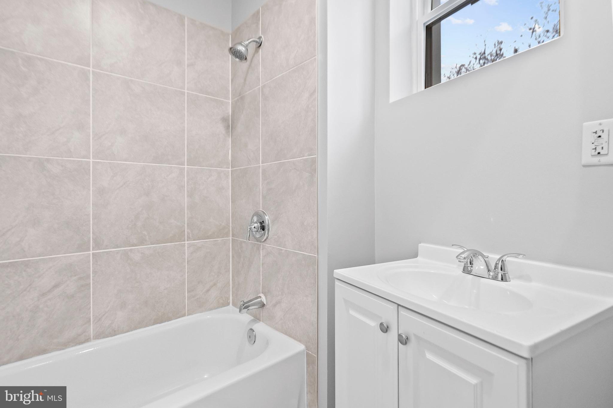 2706 Greenmount Avenue Baltimore, MD 21218 - Photo 16 of 20 a bathroom with a sink and a bathtub