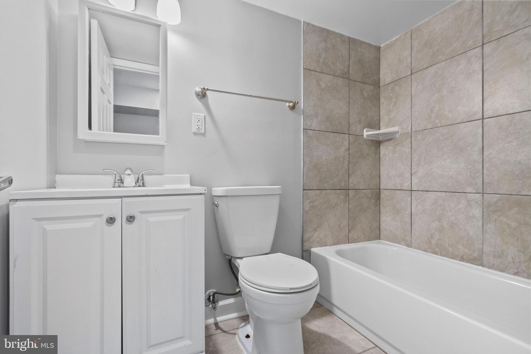 2706 Greenmount Avenue Baltimore, MD 21218 - Photo 19 of 20 a bathroom with a sink a toilet and shower