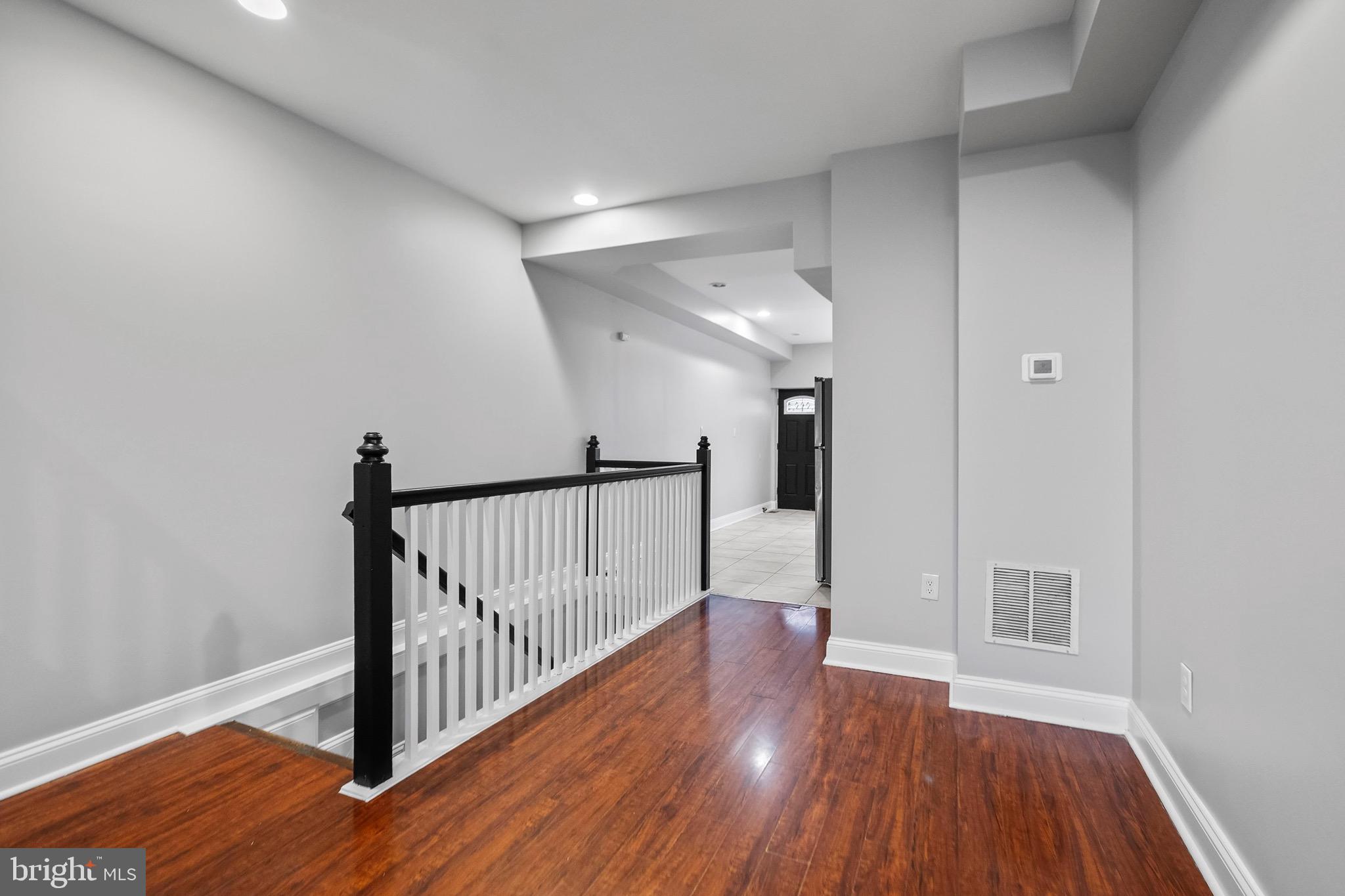 2706 Greenmount Avenue Baltimore, MD 21218 - Photo 7 of 20 a view of a hallway with wooden floor