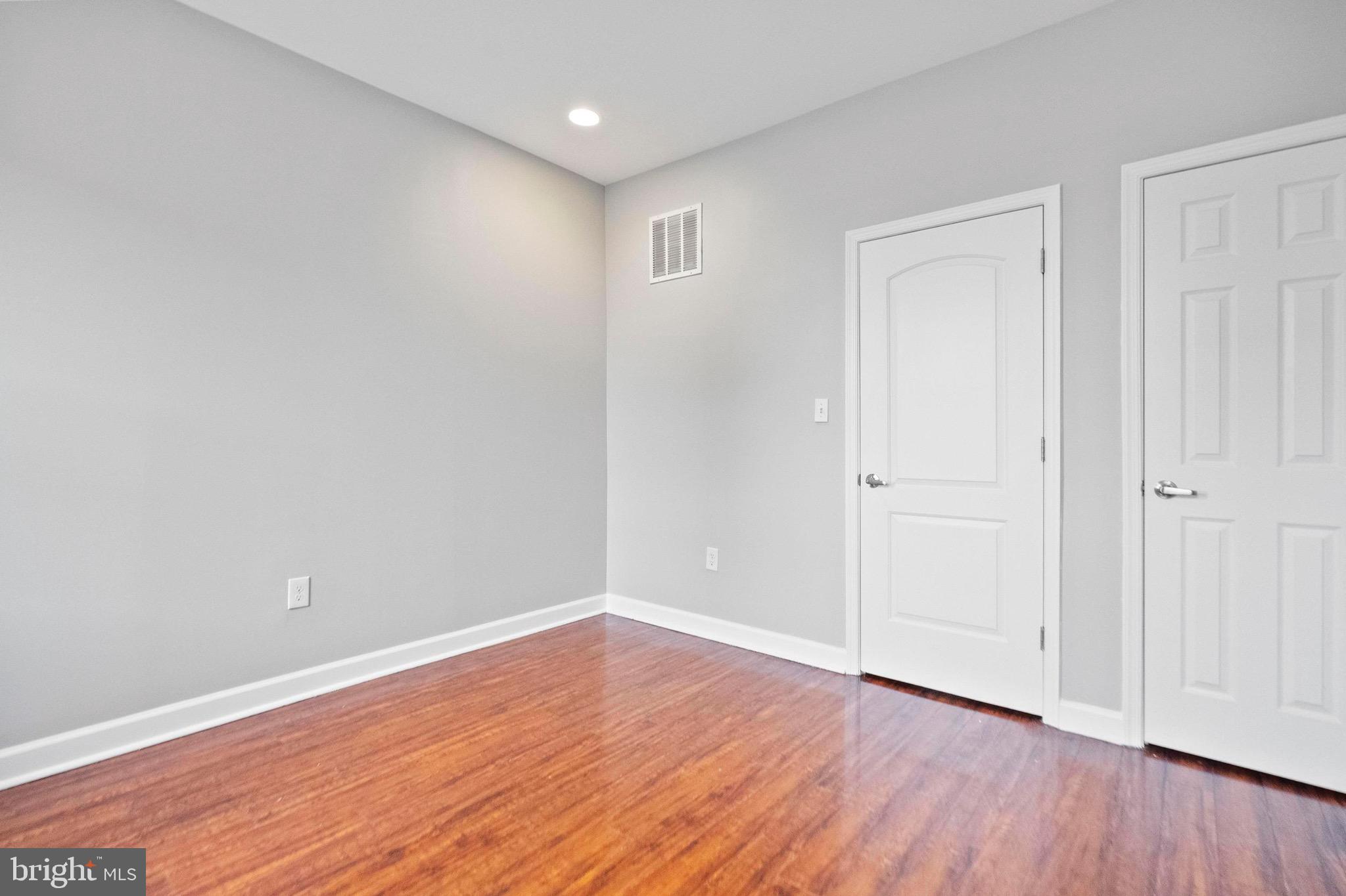 2706 Greenmount Avenue Baltimore, MD 21218 - Photo 9 of 20 a view of an empty room with wooden floor