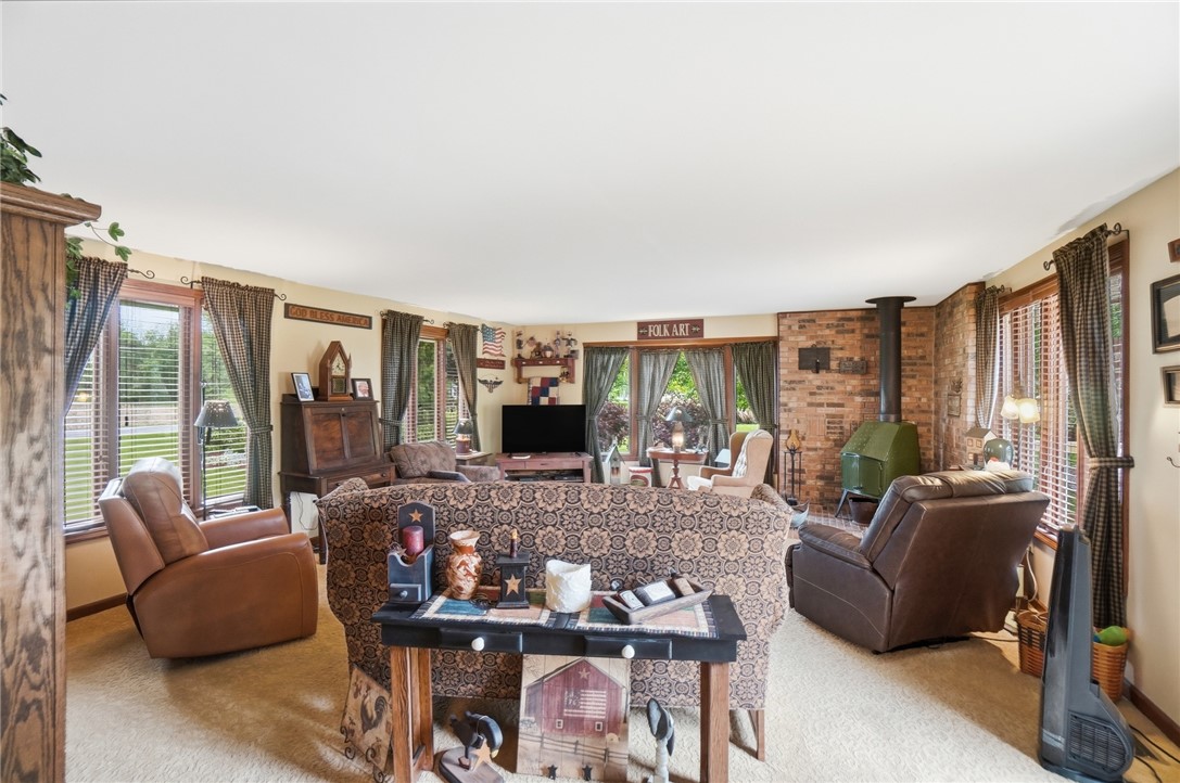 4170 Johnson Road Springfield, OH 45502 - Photo 14 of 54 A comforting living area features a brick accent wall with a classic wood-burning stove.