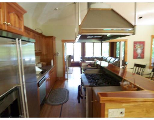 70 Stowell Road Ashburnham, MA 01430 - Photo 3 of 17 a kitchen with stainless steel appliances kitchen island granite countertop a refrigerator a stove and a sink