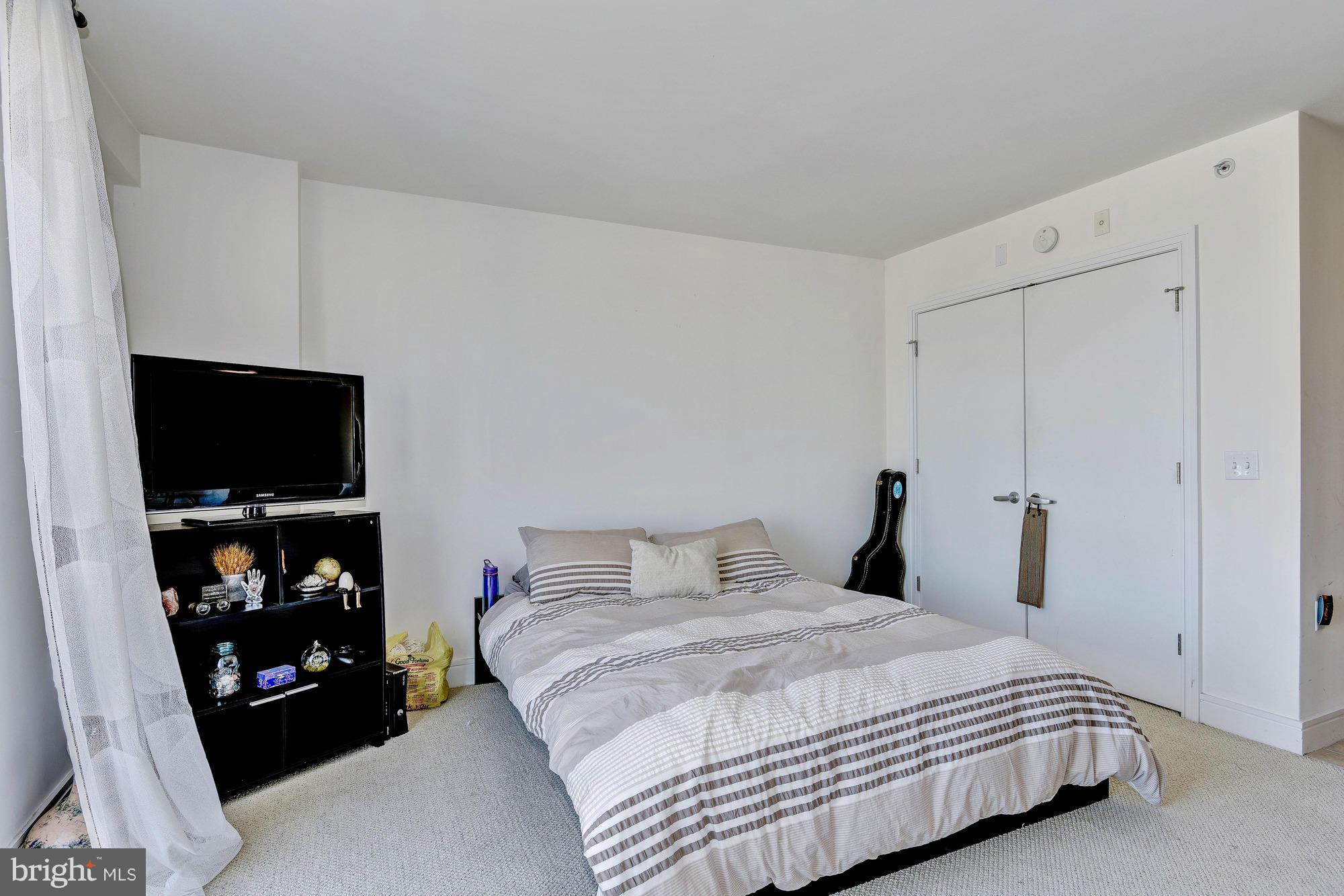 800 4th Street Southwest, Unit S615 Washington, DC 20024 - Photo 12 of 28 a bedroom with a bed and a flat screen tv