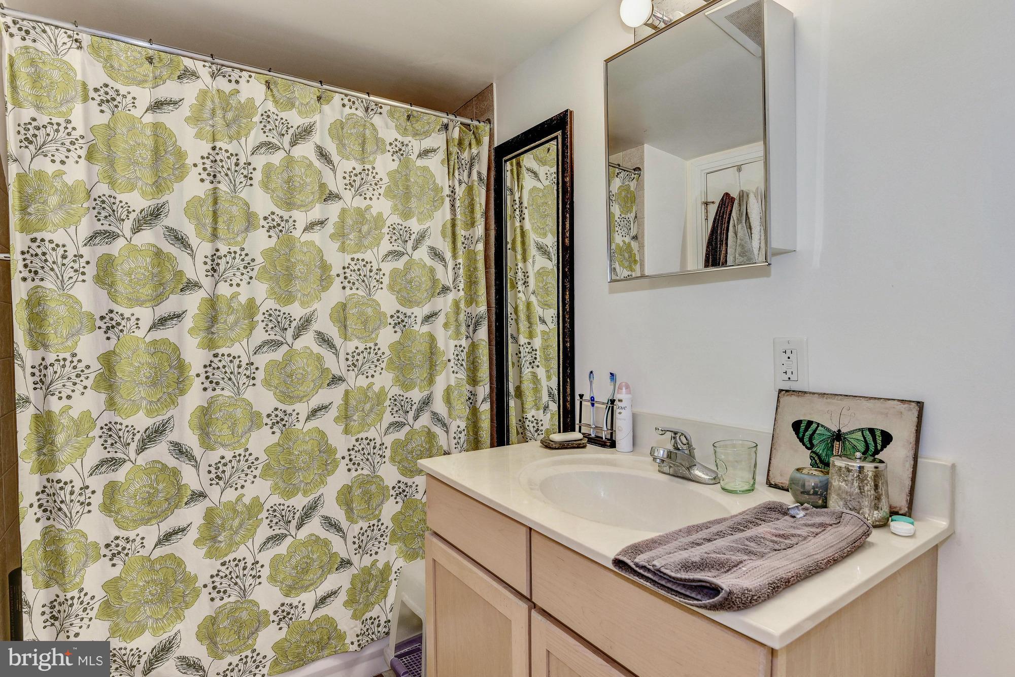 800 4th Street Southwest, Unit S615 Washington, DC 20024 - Photo 15 of 28 a bathroom with a granite countertop sink and a mirror