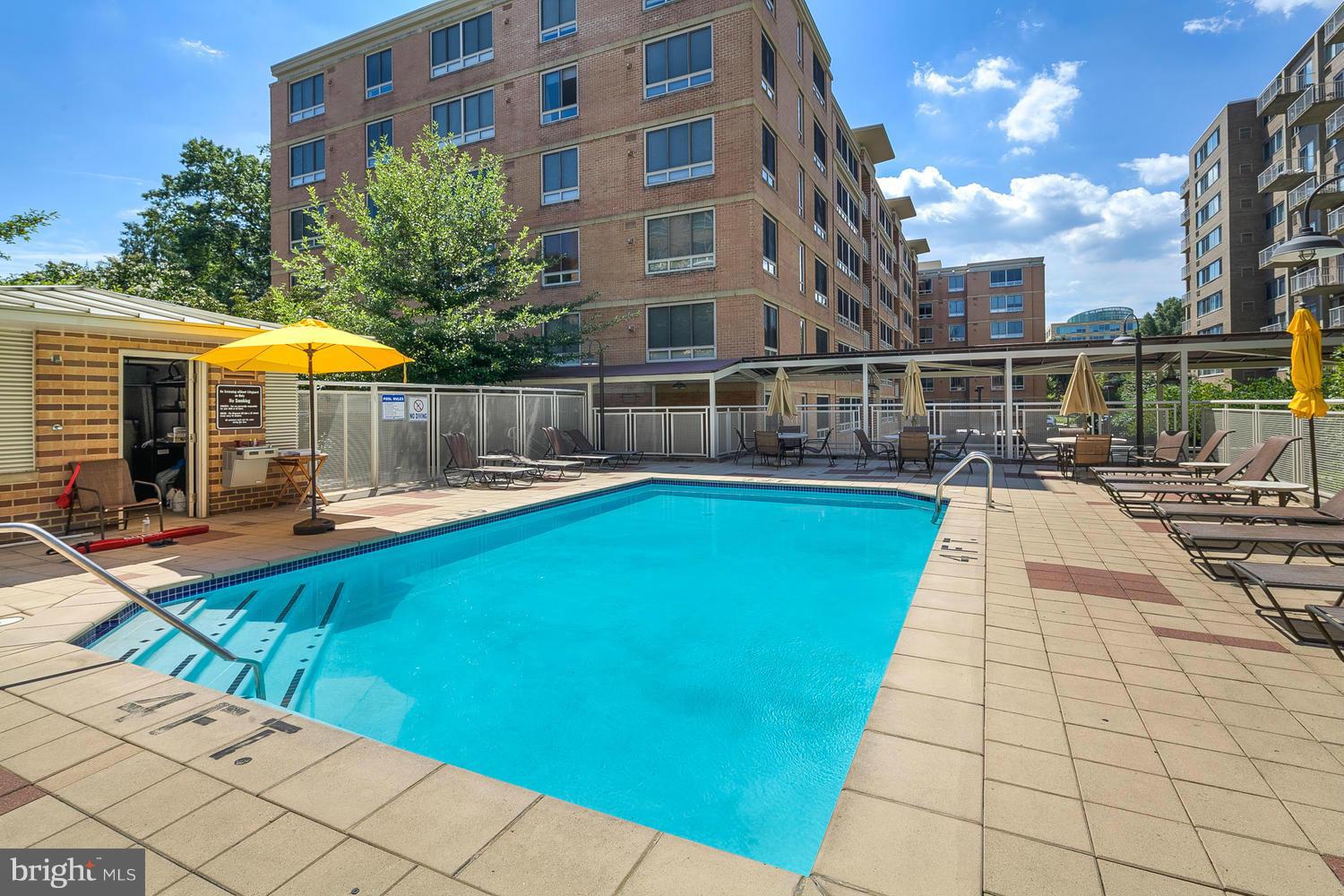 800 4th Street Southwest, Unit S615 Washington, DC 20024 - Photo 24 of 28 a view of a swimming pool with a lounge chairs