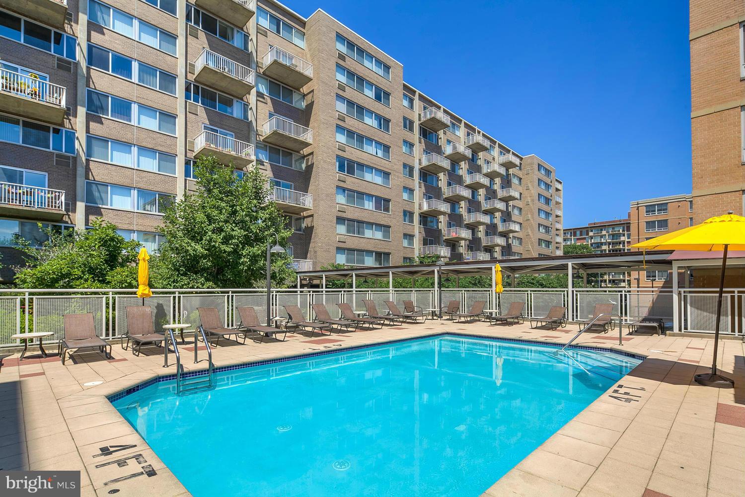 800 4th Street Southwest, Unit S615 Washington, DC 20024 - Photo 25 of 28 a view of a swimming pool with a lounge chairs