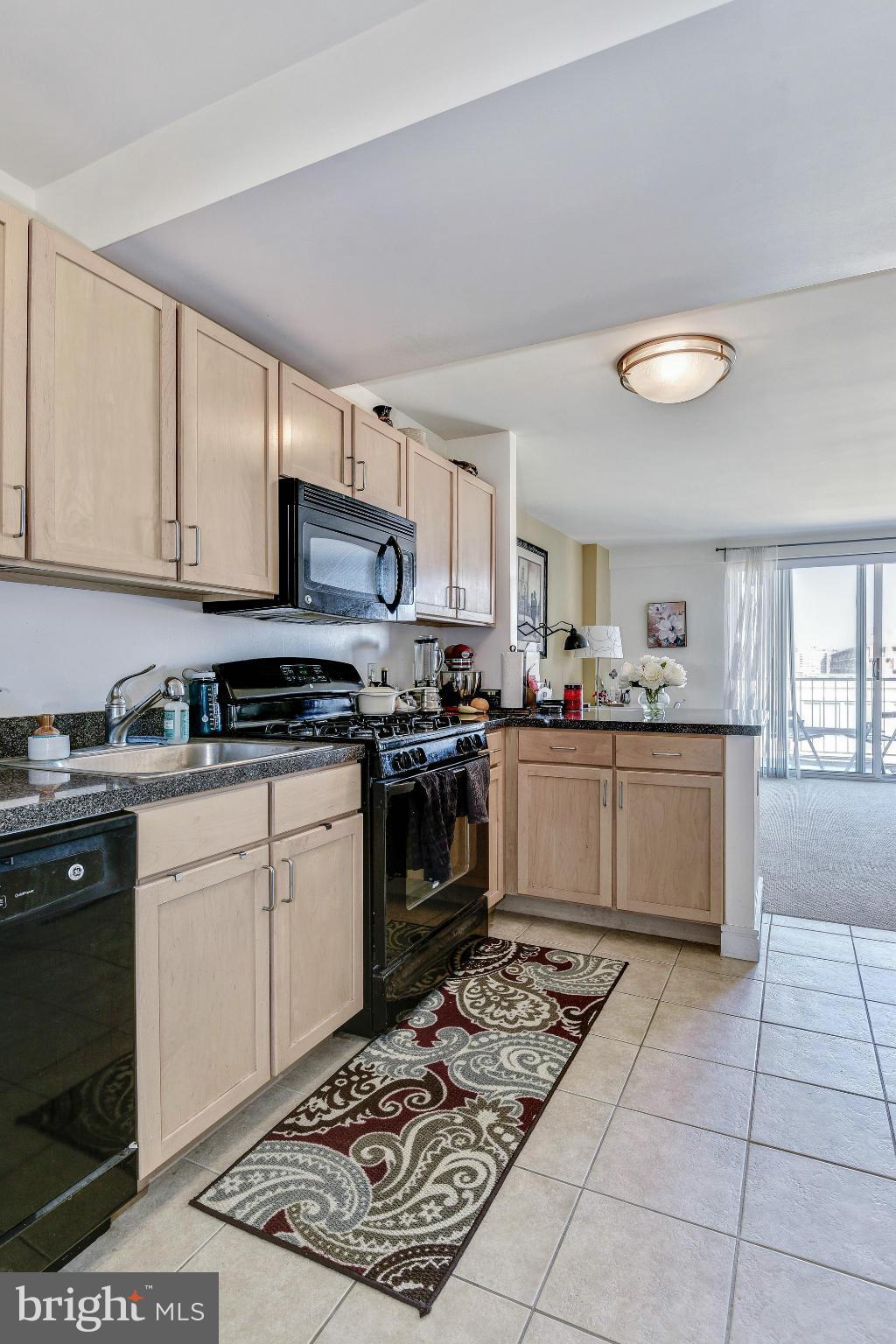 800 4th Street Southwest, Unit S615 Washington, DC 20024 - Photo 4 of 28 a kitchen with stainless steel appliances granite countertop a stove a sink and a microwave
