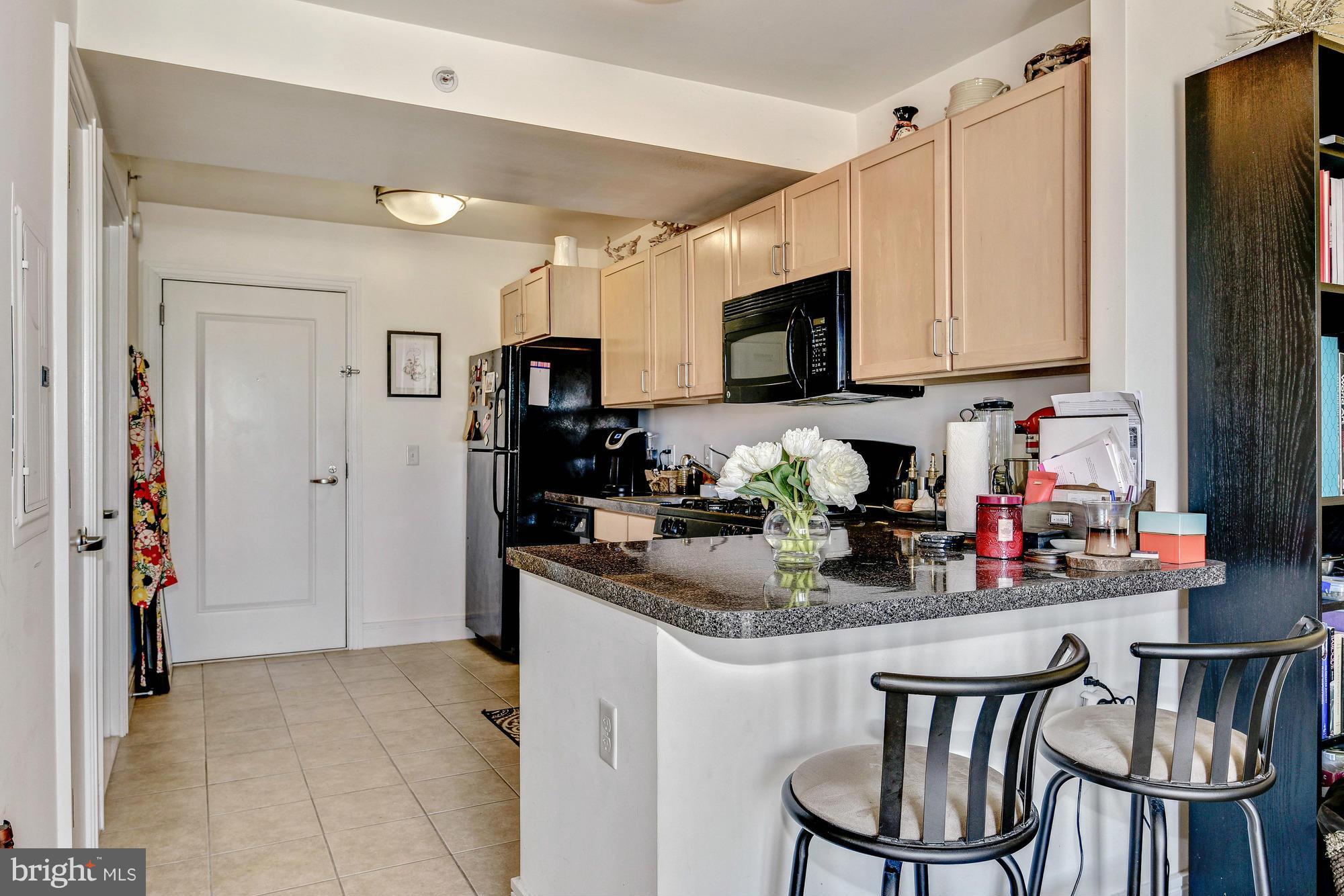 800 4th Street Southwest, Unit S615 Washington, DC 20024 - Photo 6 of 28 a kitchen with stainless steel appliances granite countertop a kitchen island a stove a table and chairs