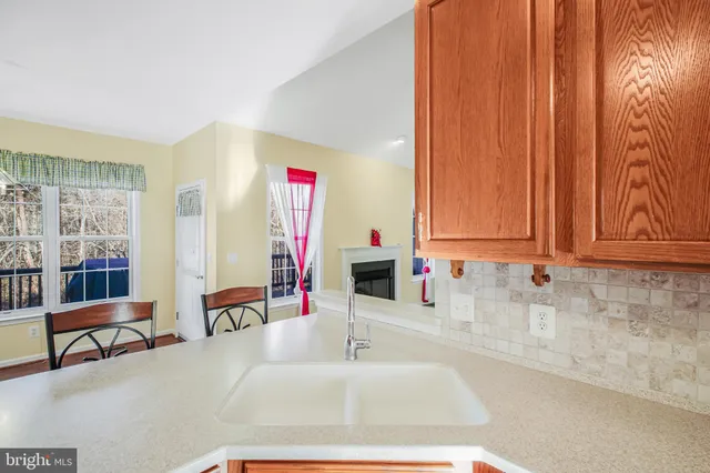 a kitchen with granite countertop a sink and white cabinets