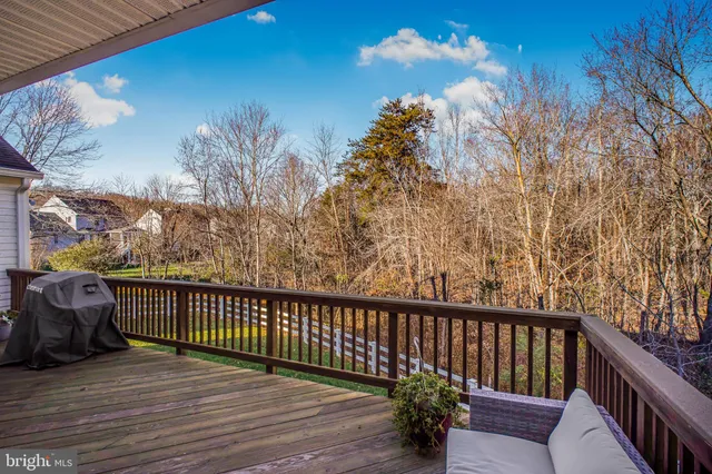 a balcony with wooden floor and fence