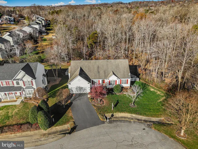an aerial view of a house with a yard and a garage
