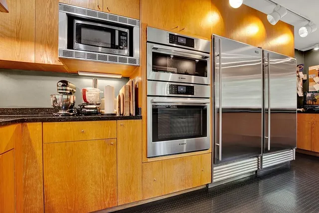 a kitchen with stainless steel appliances a stove and a refrigerator