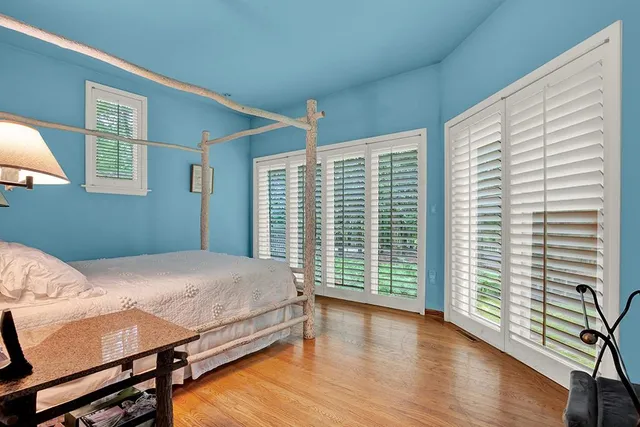 a bedroom with a bed and a large window