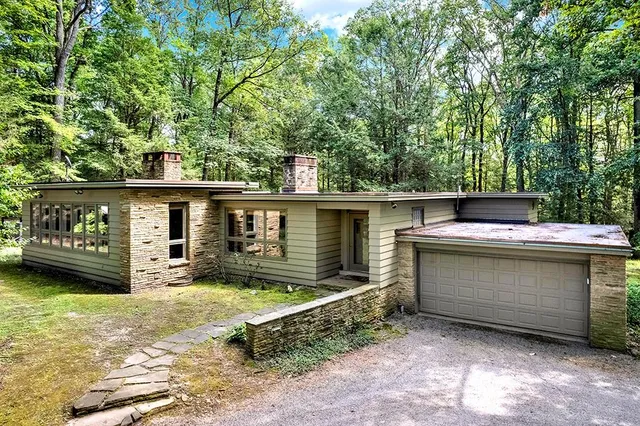 a view of a house with a large window and a yard
