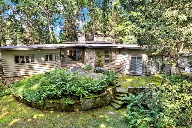 a front view of a house with garden