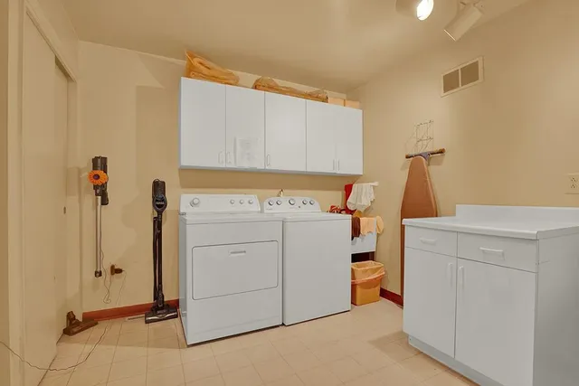 a view of a storage & utility room with closet dryer