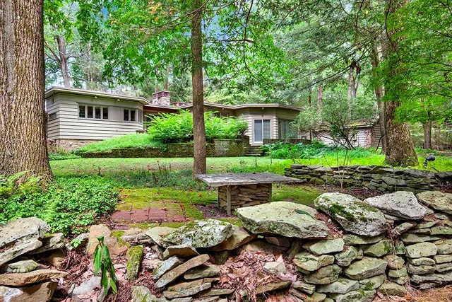 a view of backyard with plants and outdoor seating