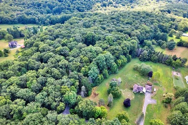 an aerial view of a house with a yard