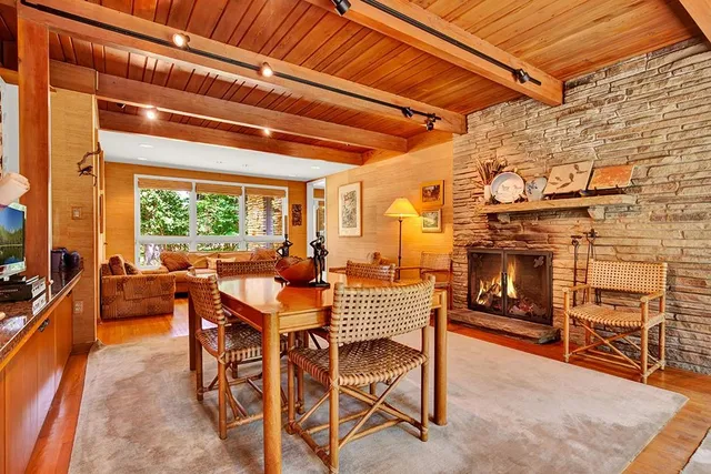 a dining room with furniture and a fireplace