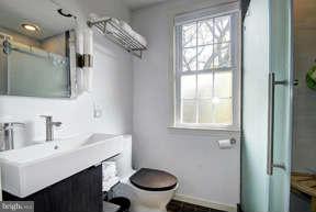 2719 Ordway Street Northwest, Unit 6 Washington, DC 20008 - Photo 11 of 12 a bathroom with a sink a toilet and a mirror