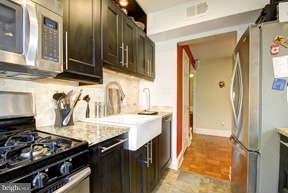 2719 Ordway Street Northwest, Unit 6 Washington, DC 20008 - Photo 8 of 12 a kitchen with granite countertop a stove and a sink