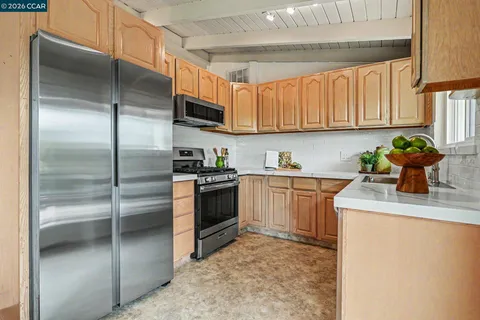 a kitchen with a sink stainless steel appliances and cabinets