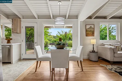 a view of a dining room with furniture window and outside view