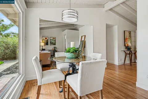 a view of a dining room with furniture window and wooden floor