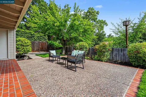 a view of a backyard with sitting area