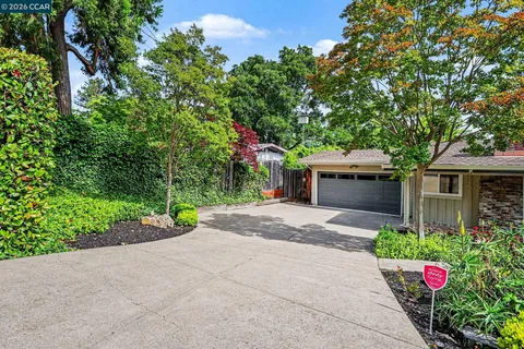 a front view of a house with a yard and a garage