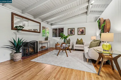 a living room with furniture a fireplace and next to a window