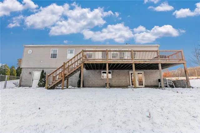 a roof deck with table and chairs