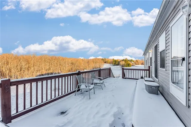 an aerial view of a house with a yard and wooden fence