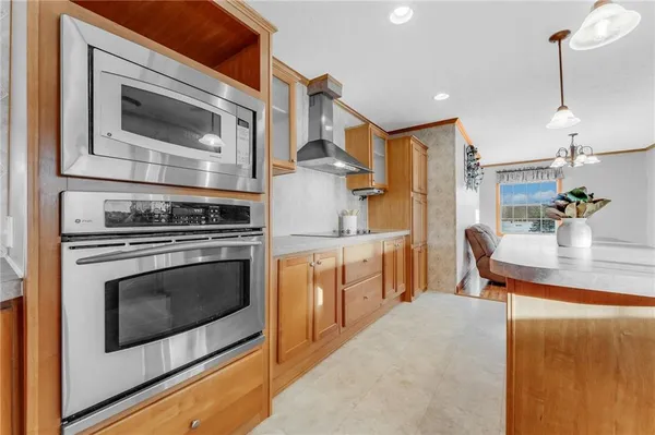 a kitchen with stainless steel appliances granite countertop a sink and a refrigerator
