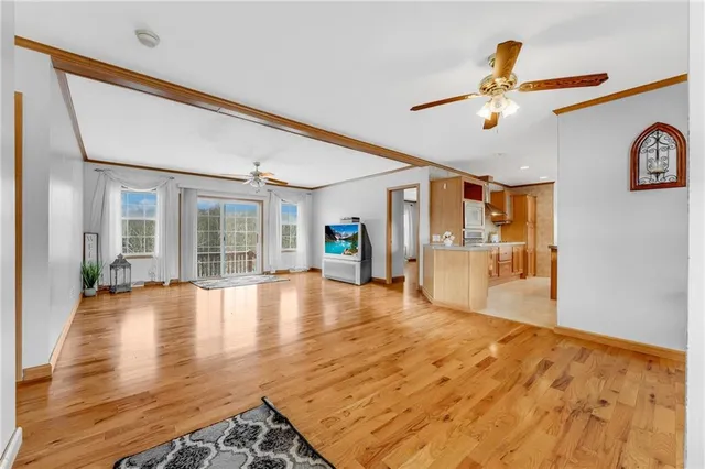 a view of a kitchen with wooden floor and a refrigerator