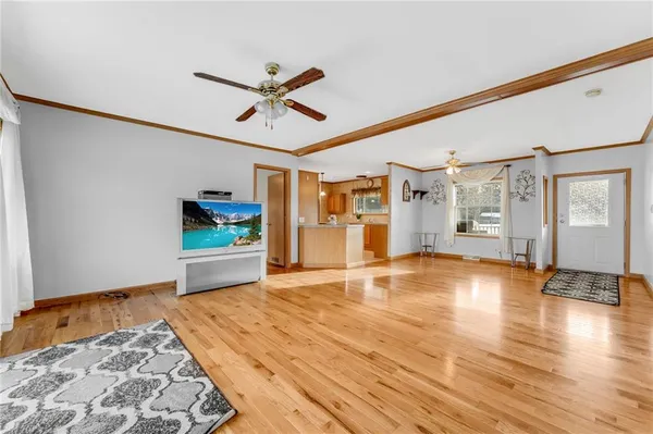 a living room with furniture and kitchen view