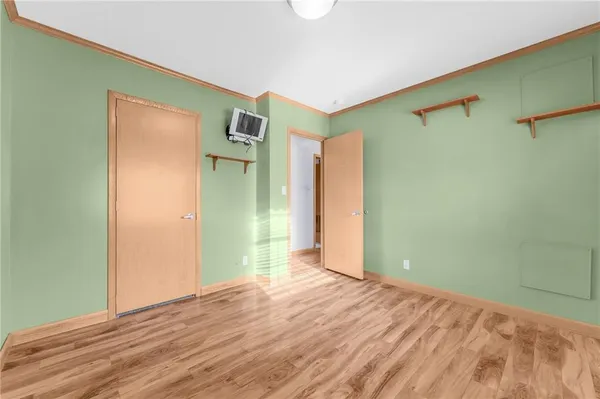 a view of a room with wooden floor and a ceiling fan